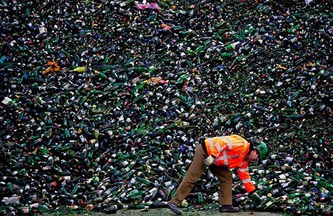 Ngày 2/1, một người lao động tại nhà máy tái chế thủy tinh ở Maltha, Heijningen, Hà Lan đang xếp gọn đống vỏ chai bia khổng lồ sau lễ Giáng sinh. (Ảnh: Getty Images)