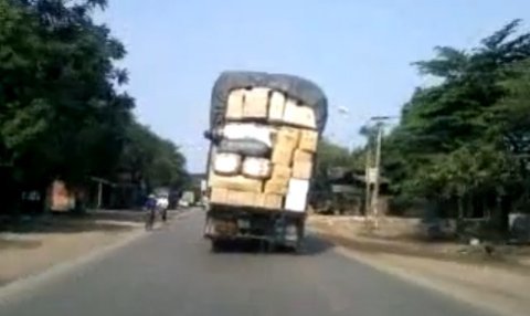 Ô tô chở đầy hàng 'làm xiếc' trên đường