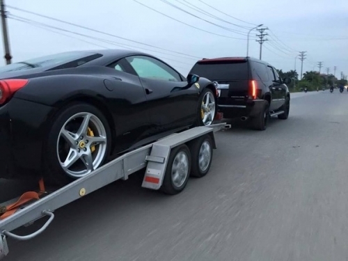 Đại gia Hà Nội mang ‘khủng long’ Cadillac kéo Ferrari 458 trên đường