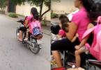 Người phụ nữ đèo 3 trẻ nhỏ, vừa lái xe một tay vừa cho con bú