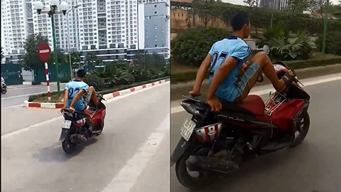 Nam thanh niên lái xe máy bằng chân, đi vào làn buýt nhanh