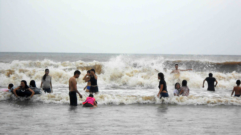 Đưa cả trẻ con hồn nhiên giỡn sóng trước bão ở biển Sầm Sơn