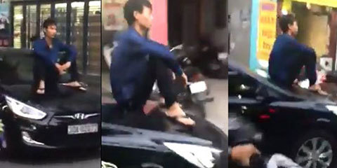 Nam thanh niên ngồi trên mui xế hộp đang chạy